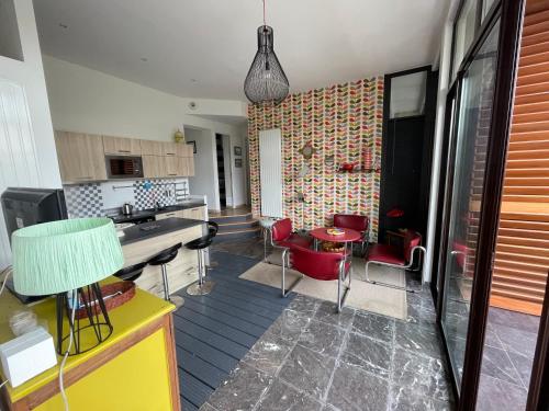 a kitchen with a table and chairs in a room at Villa Julie in Biarritz