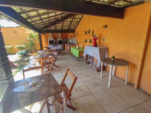 a patio with tables and chairs and a room with tables and chairs at Flats vila bela Búzios in Búzios