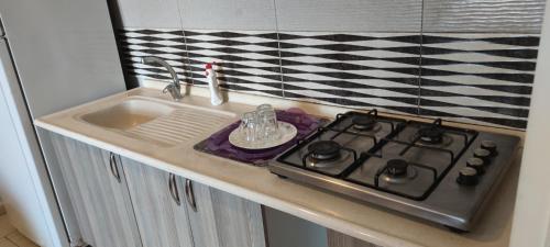 a kitchen counter with a stove and a sink at Midtown Hotel Apartments 404 ( 2+1) in Istanbul