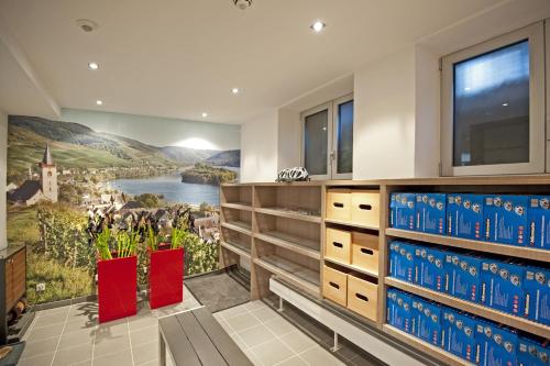 a kitchen with a wall mural of a farm and a river at Hotel Im Schulhaus in Lorch am Rhein