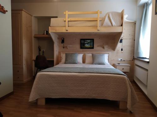 a bedroom with a bed with two bunk beds at Al San Michele in Stresa