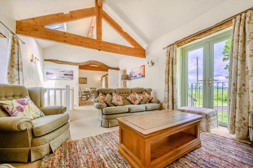 a living room with a couch and a table at Pickle Barn in Lupton