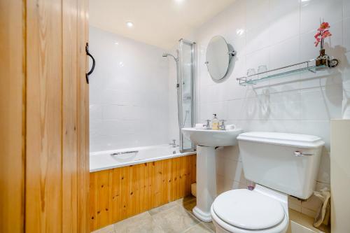 a bathroom with a toilet and a sink and a shower at Pickle Barn in Lupton