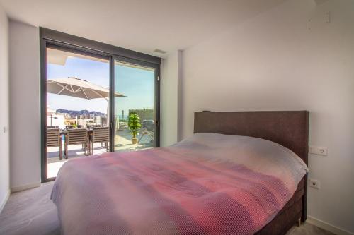 um quarto com uma cama e uma grande janela em Villa Esmeralda 20 by BookaParadise em Finestrat