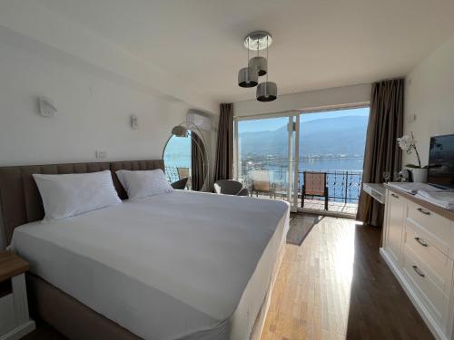 a bedroom with a bed and a view of the ocean at Villa Una in Ohrid