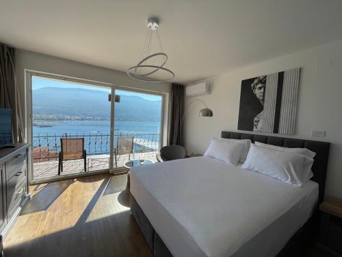 a bedroom with a large bed and a large window at Villa Una in Ohrid