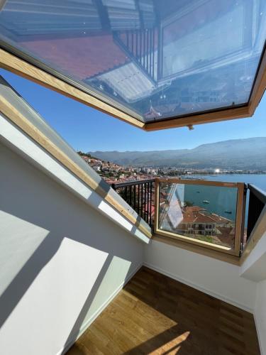 a view from the balcony of a house with a large window at Villa Una in Ohrid