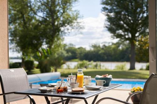 a table with food and drinks on a patio at Clos Bernon in Libourne