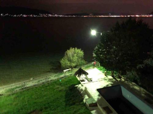 a view of a park at night with a street light at Sea view luxury apartment in Aiándion