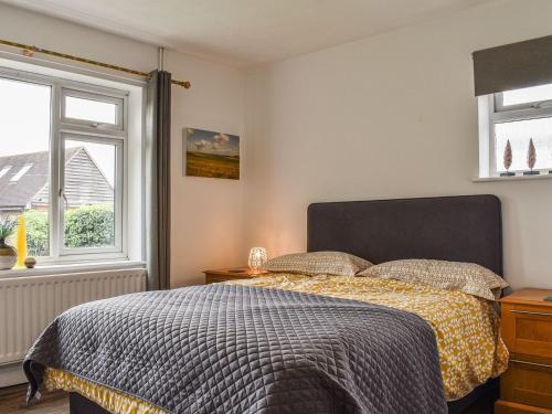 a bedroom with a bed and a window at The Horseshoe Annex in Steyning