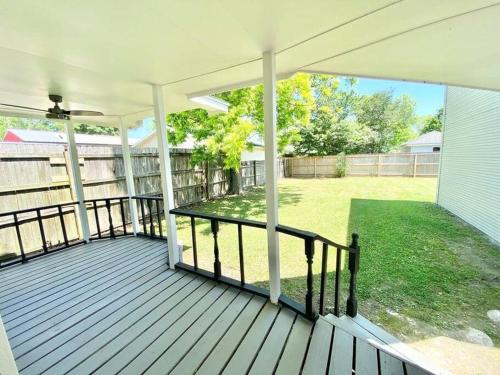 a covered porch with a view of a yard at 6 BRs Spacious Charming House, Great Neighborhood in Groves