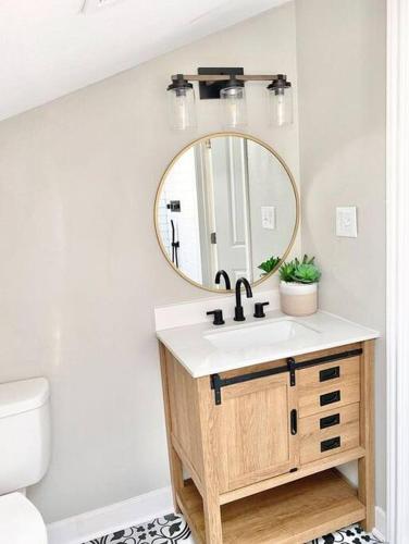 a bathroom with a sink and a mirror at 6 BRs Spacious Charming House, Great Neighborhood in Groves