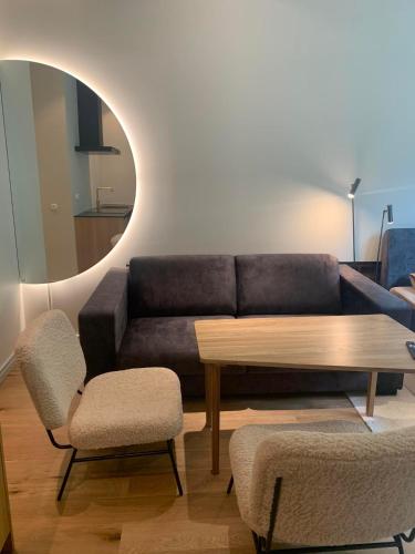 a living room with a couch and a table and chairs at Vallikraavi Studio Apartment in Tartu