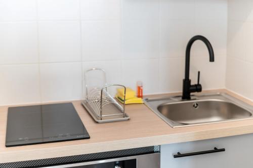 a kitchen counter top with a sink and a sink at Appartement Terreau in Manosque