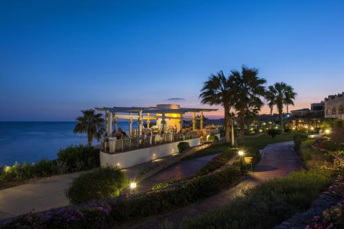 a building with a view of the ocean at night at Concorde El Salam Sharm El Sheikh Front Hotel in Sharm El Sheikh