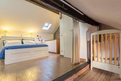 a bedroom with a bed and a crib at Casa al Lago di Como in Riva Cernobbio in Cernobbio