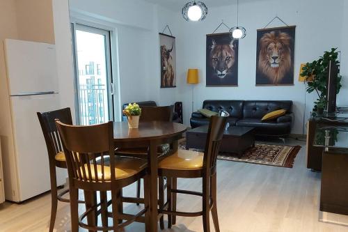 a living room with a table and chairs and a couch at Deluxe Apartment on YAS with Sea View Balcony in Abu Dhabi