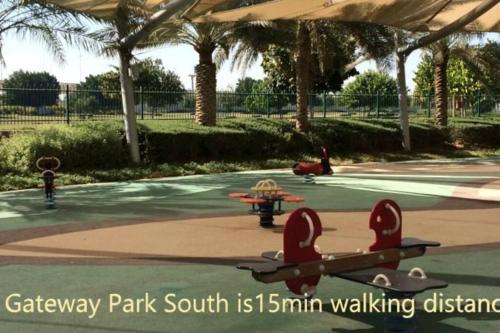a park with toy planes and a park with palm trees at Deluxe Apartment on YAS with Sea View Balcony in Abu Dhabi