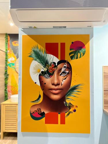 a poster of a black woman with flowers on her head at Capsule Safari - Jacuzzi - Nintendo Switch - Netflix & Home cinéma - Pouf géant - Filet suspendu in Douai