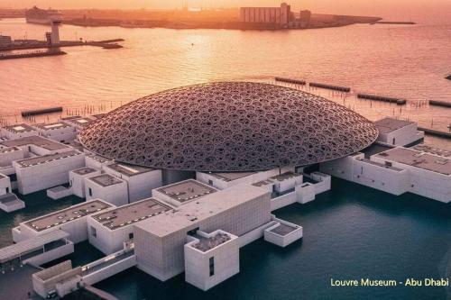 an aerial view of a building in the water at Deluxe Apartment on YAS with Sea View Balcony in Abu Dhabi