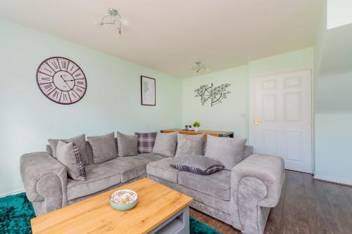 a living room with a couch and a table at Central Townhouse Tipton - Sleeps 8 - Ideal for Contractors & Families in Tipton