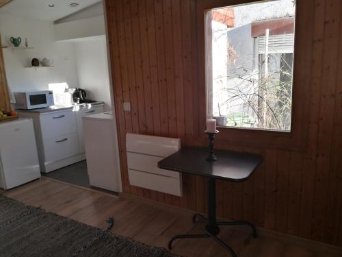 a small table in a kitchen with a window at Studio with free parking Nice terrace Free WiFi connection in Geneva