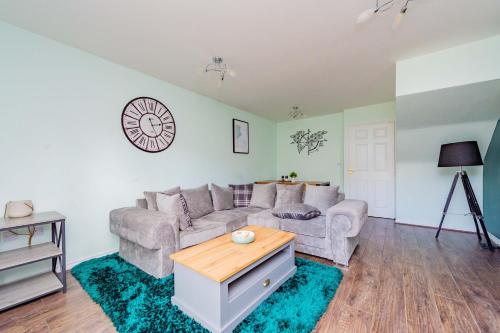 a living room with a couch and a table at Central Townhouse Tipton - Sleeps 8 - Ideal for Contractors & Families in Tipton