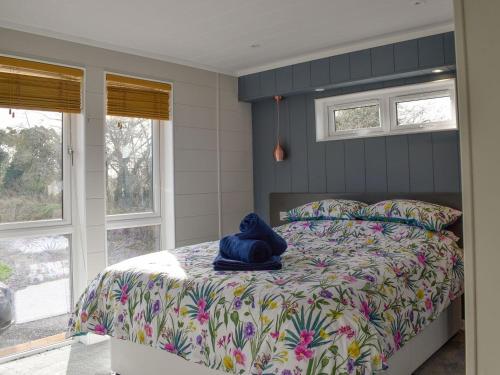 a bedroom with a bed with a blue hat on it at Whitey Top Country Lodge in Pentridge
