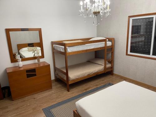 a room with a bunk bed and a mirror at Quinta do Avô Dimas - Rural Home - São Brás in Porto Formoso