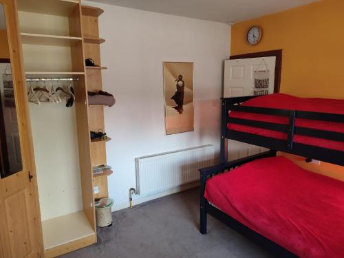 a bedroom with a bunk bed with a red bedspread at The Hideout ! in Dublin