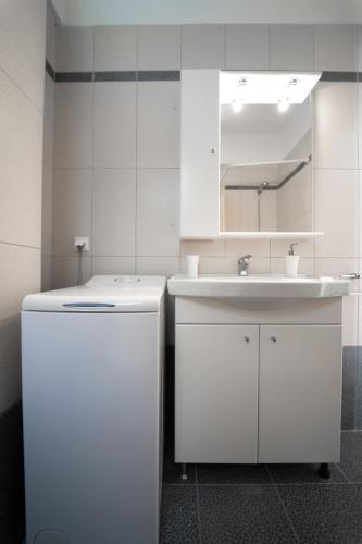 a kitchen with a sink and a white refrigerator at Aetofolia Villa in Fourka