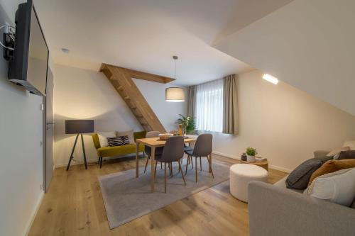 a living room with a couch and a table at Rákosárna Suites & Apartments in Špindlerův Mlýn