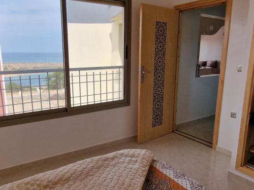 a room with a door and a view of the ocean at Dar Assalam in Oualidia