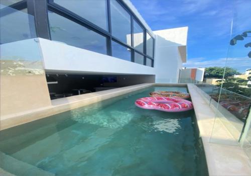 a swimming pool with two inflatables in a house at Aut&eacute;ntico Vertical Playa del Carmen in Playa del Carmen