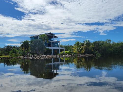 a house on an island in the middle of a lake at Laguna Tramonto in Maya Beach