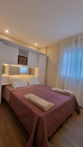 a bedroom with a bed with two towels on it at Casinha da Belavista in Arcos de Valdevez