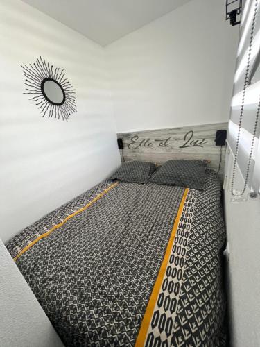 Bett in einem Zimmer mit Schild an der Wand in der Unterkunft Loriot2 - appartement vue sur mer in Ploemeur