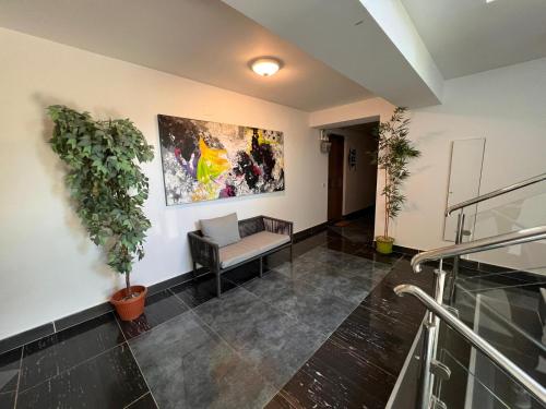 an office lobby with a chair and a painting on the wall at Terrace apartments otopeni ! in Otopeni