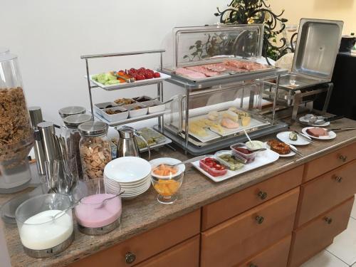 a buffet with many different types of food on a counter at Frühstückspension Herzog zu Laah in Linz