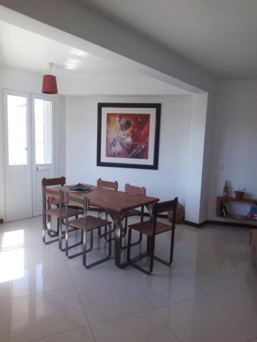 a dining room with a wooden table and chairs at Appart Chris Mindelo in Mindelo