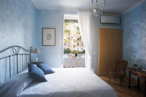 a bedroom with a bed with blue walls and a window at Sweet Dreams in St Peter B&b in Rome
