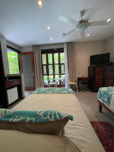a bedroom with two beds and a living room at The Haven - Hotel & Spa, Health and Wellness Accommodation - Adults Only in Boquete