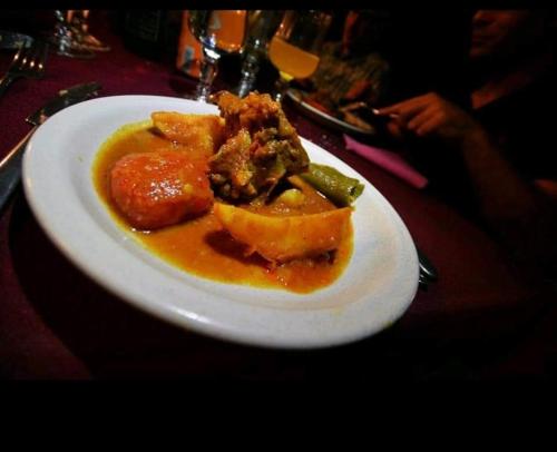a white plate of food on a table at Hotel Pansy in Ksar Ghilane