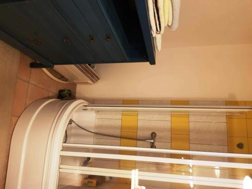 a kitchen with a refrigerator with yellow and brown tiles at Kincsesbánya in Kincsesbanya