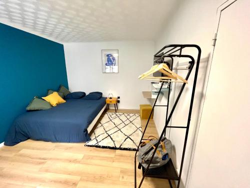 a bedroom with a blue bed and a ladder at Studio - WIFI - Train Station - Love Bridgi home in Forbach