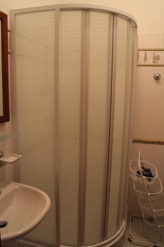 a shower with a glass door next to a sink at Apartmany A.Ša Kašperské Hory in Kašperské Hory