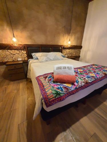 a bed with a pillow on top of it at Lodge Don Felix in San Pedro de Atacama