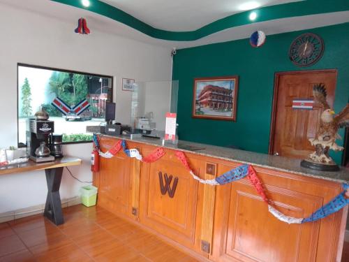 a kitchen with a counter with flags on it at Hotel Wilson Ciudad Neily in Neily
