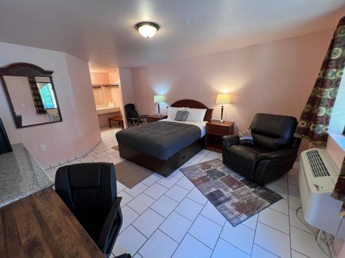 a bedroom with a bed and a couch and a chair at Frazier View Motel in Frazier Park