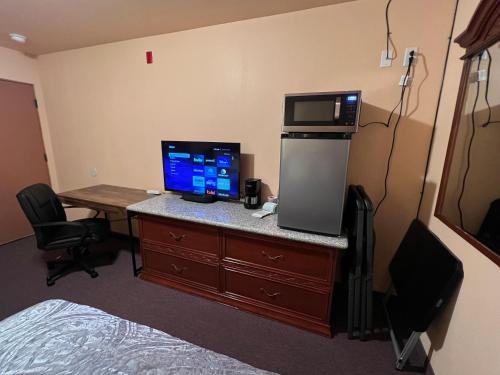 a hotel room with a desk with a computer on it at Frazier View Motel in Frazier Park